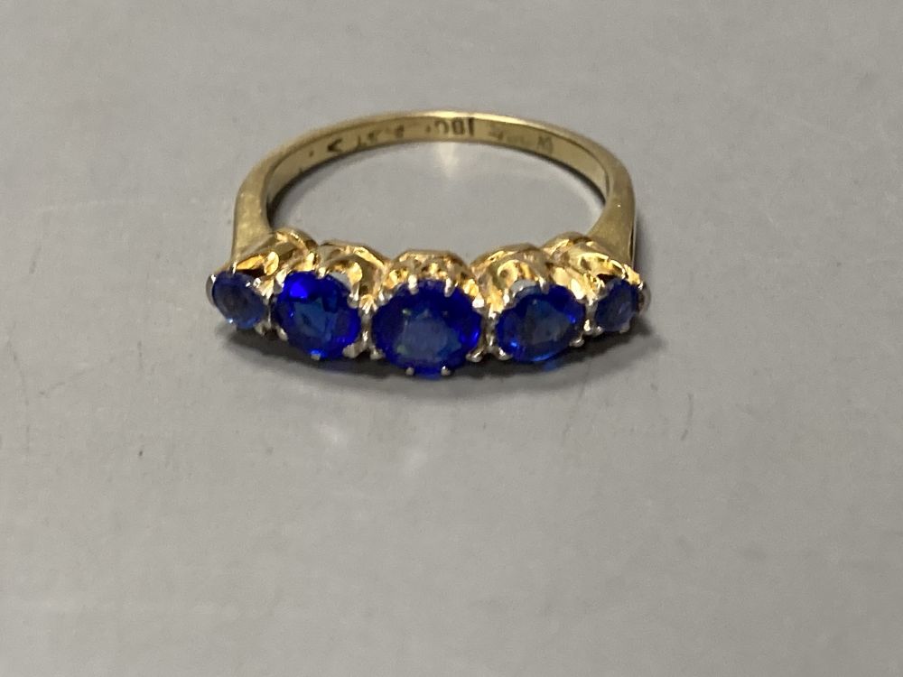 An 18ct and plat. graduated five blue stone doublet half hoop ring, size L, gross 3.1 grams.